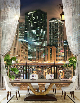 Балкон с видом на ночной город в интерьере кухни с большим столом