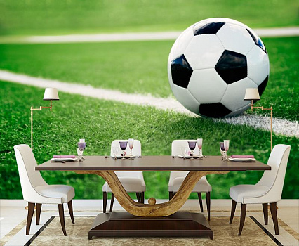 Футбольный мяч на траве в интерьере кухни с большим столом
