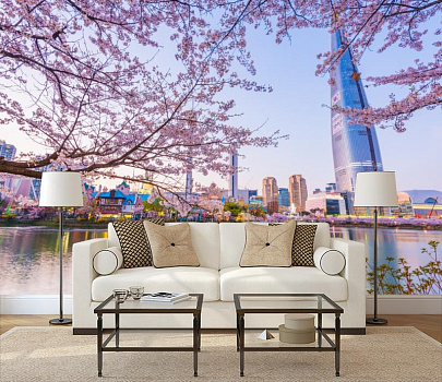 Цветущая сакура над городом в интерьере гостиной с диваном