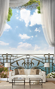 Кованный балкон с видом на море в интерьере гостиной с диваном