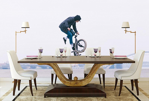 Велосипедный трюкач в интерьере кухни с большим столом