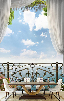 Кованный балкон с видом на море в интерьере кухни с большим столом
