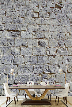 Каменная стена серо-синяя в интерьере кухни с большим столом